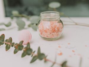 Calming spa scene featuring pink bath salt and eucalyptus for a relaxing experience.
